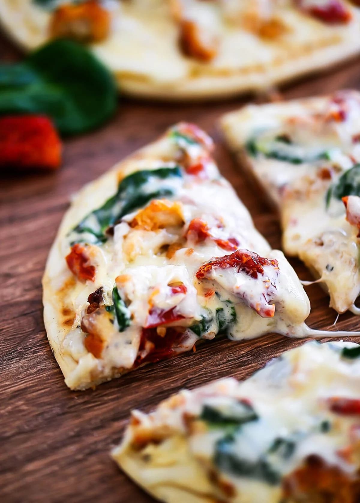 Tuscan Garlic Chicken Pita Pizzas with Creamy Alfredo and Sun-Dried Tomatoes